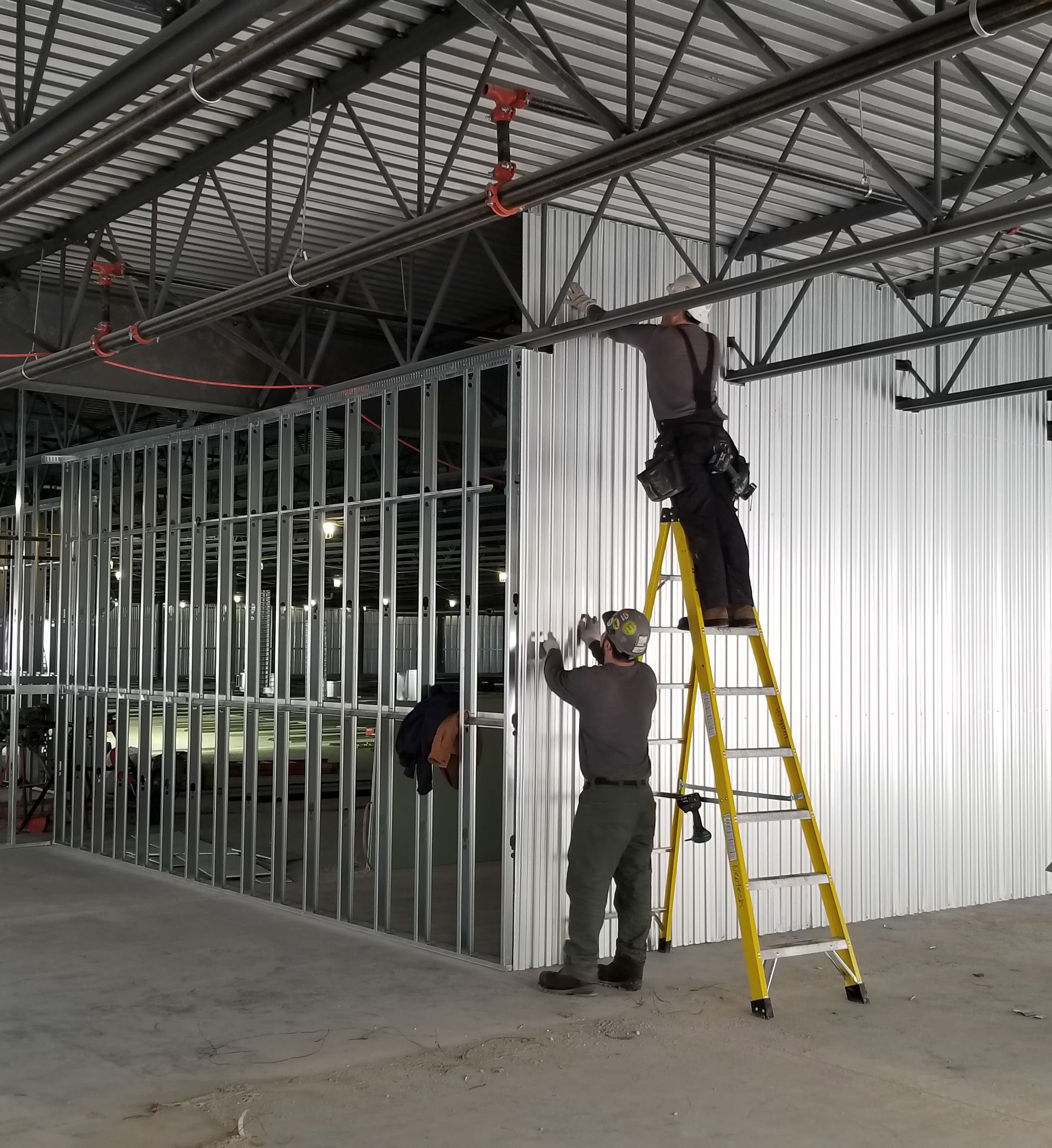 NeoTech crew installing interior locker partitions in a self-storage facility