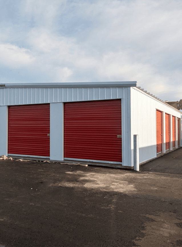 Drive-up mini storage building with red roll-up doors manufactured by NeoTech
